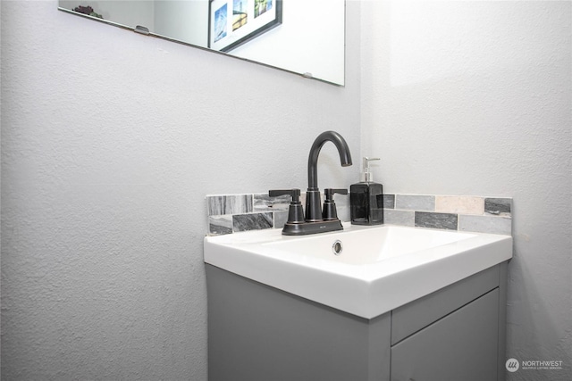 bathroom featuring tasteful backsplash and vanity