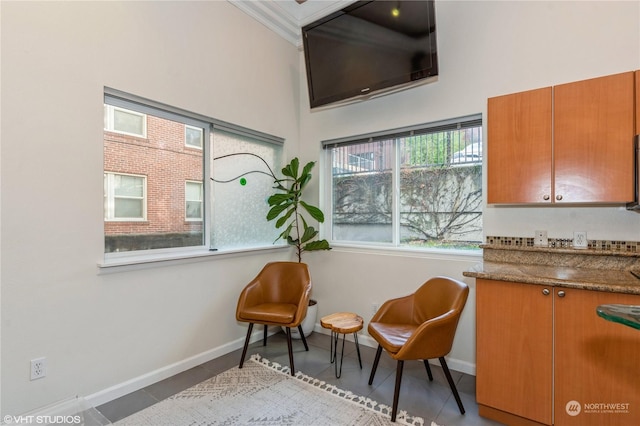 sitting room featuring crown molding and light tile patterned floors