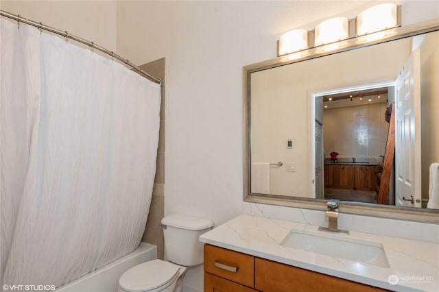 full bathroom with vanity, toilet, and shower / tub combo with curtain