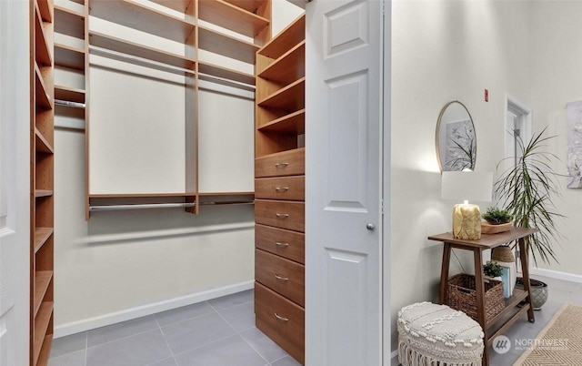 spacious closet with tile patterned floors