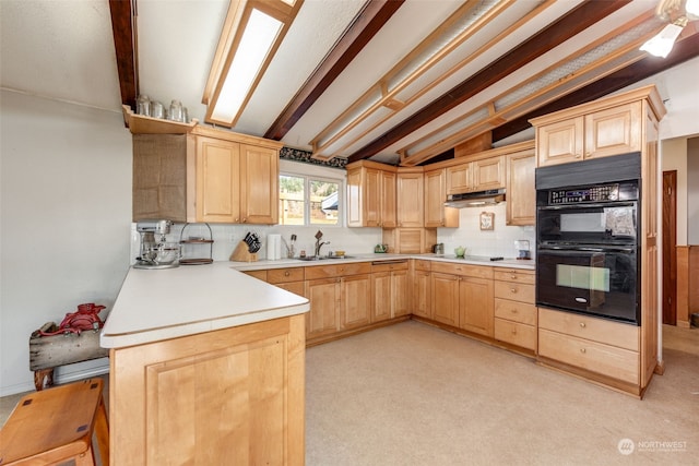 kitchen with kitchen peninsula, light brown cabinetry, double oven, sink, and lofted ceiling with beams