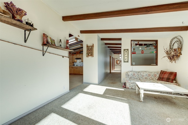 interior space featuring beam ceiling and light carpet