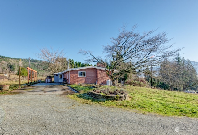 view of property exterior with a mountain view