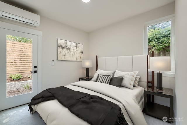 bedroom with a wall mounted air conditioner and carpet