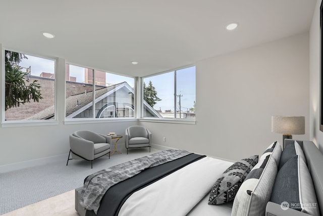 carpeted bedroom featuring multiple windows