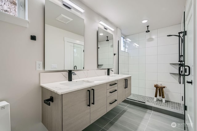 bathroom with tile patterned flooring, vanity, and an enclosed shower