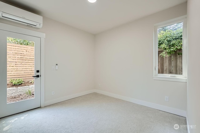 empty room with light carpet, plenty of natural light, and a wall mounted AC