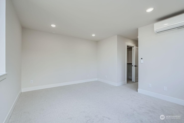 carpeted spare room featuring a wall mounted AC