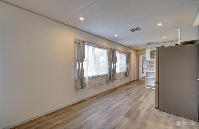 empty room with light hardwood / wood-style floors