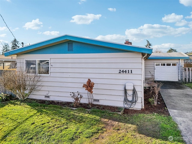 view of property exterior with a lawn and a garage