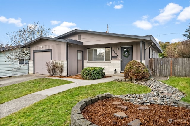 view of front of home with a garage and a front lawn