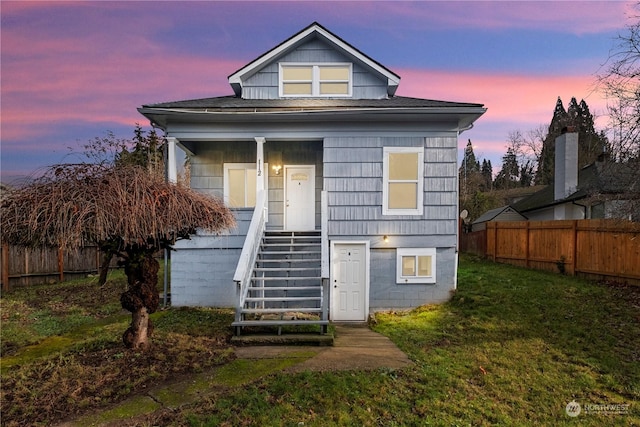 bungalow-style home with a lawn