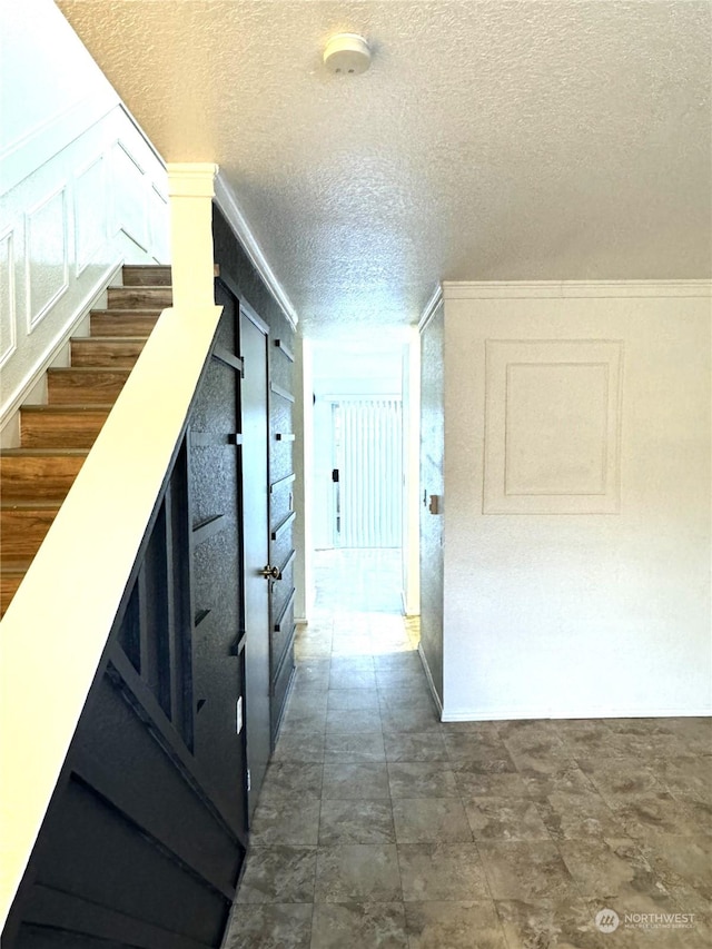 corridor featuring a textured ceiling