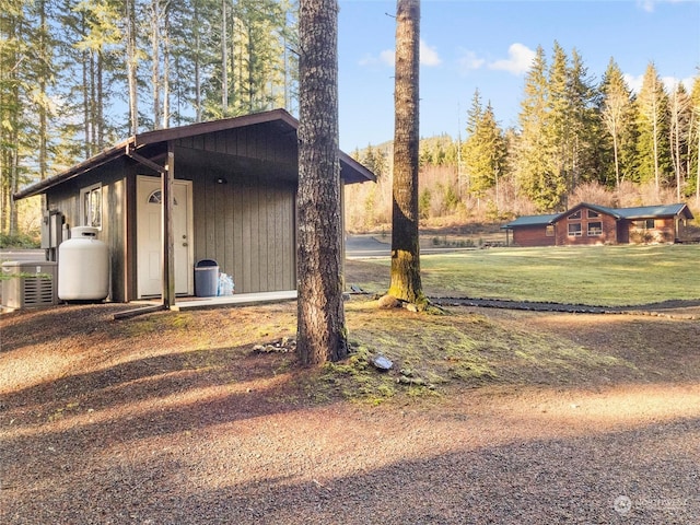 view of home's exterior featuring central air condition unit and a lawn