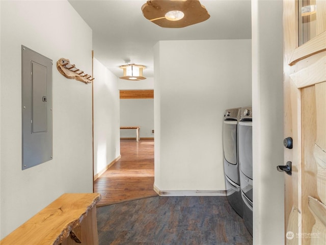 washroom featuring electric panel, washer and dryer, and dark hardwood / wood-style floors