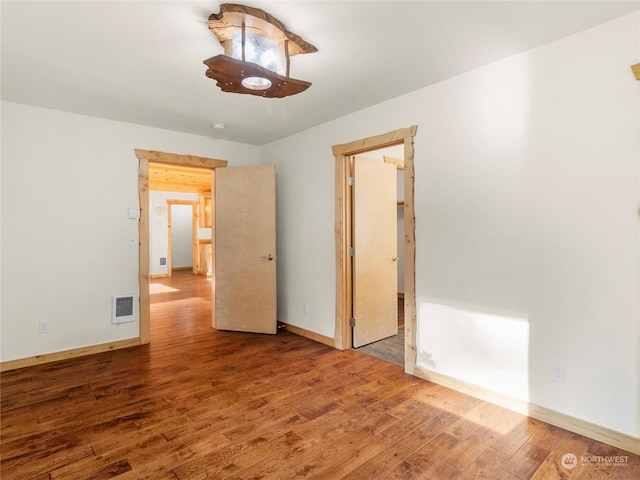 empty room featuring wood-type flooring