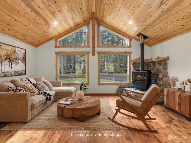 living room with high vaulted ceiling, wooden ceiling, light wood-type flooring, and a wood stove