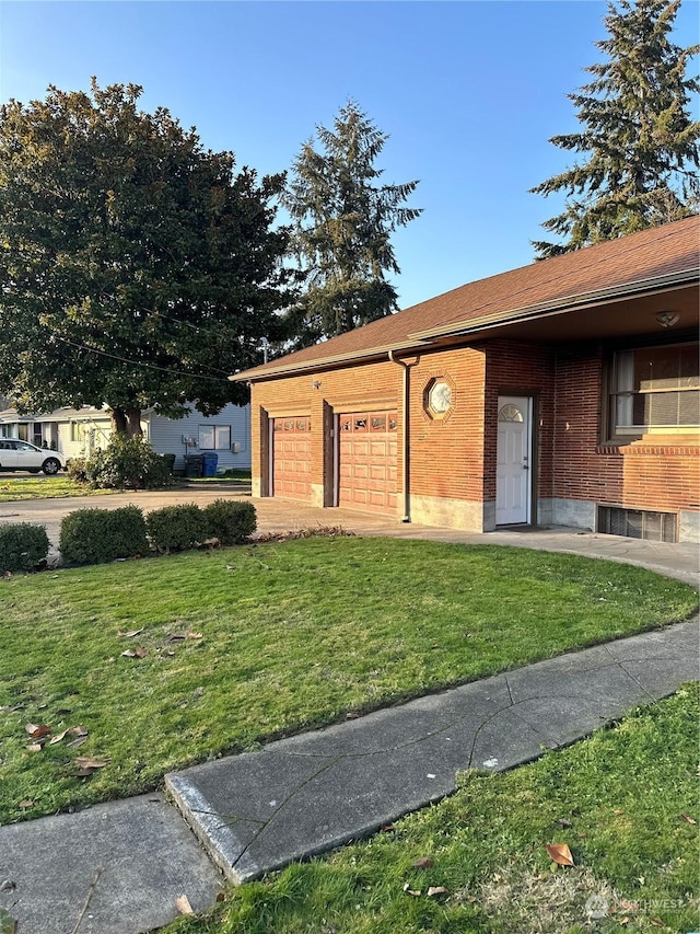 entrance to property featuring a yard and a garage