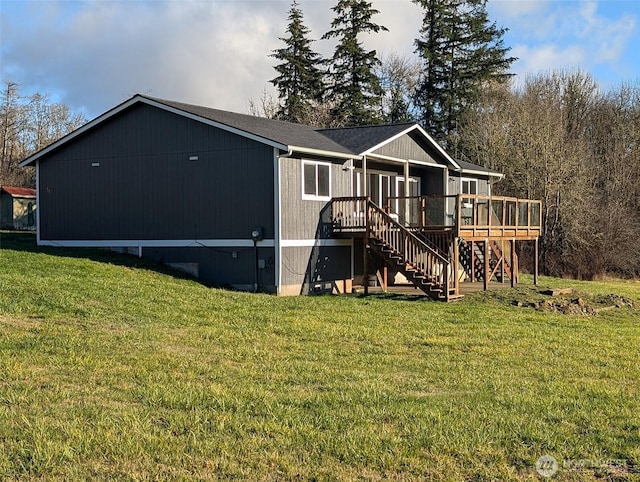 back of house featuring stairs, a yard, and a wooden deck