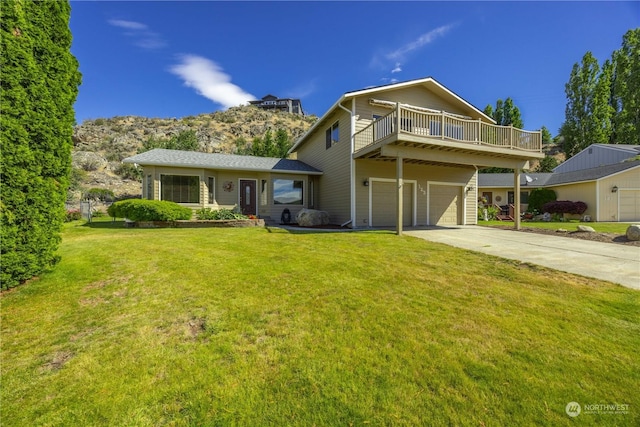 view of front property featuring a garage, a deck, and a front yard