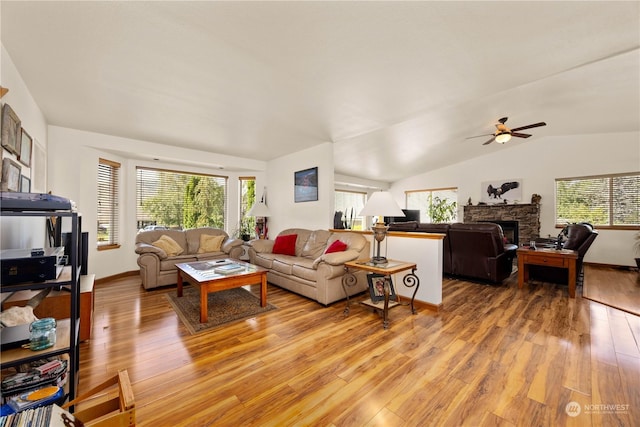 living room featuring lofted ceiling, a wealth of natural light, and light hardwood / wood-style flooring