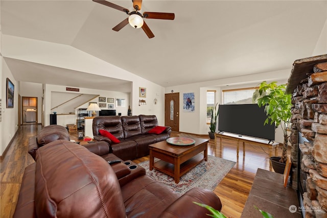 living room with hardwood / wood-style flooring, vaulted ceiling, and ceiling fan