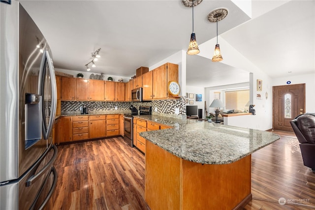 kitchen with kitchen peninsula, dark hardwood / wood-style flooring, backsplash, stainless steel appliances, and decorative light fixtures