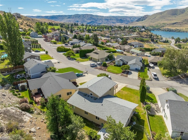 bird's eye view with a water and mountain view