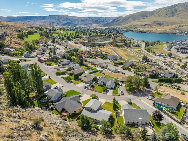 drone / aerial view featuring a water and mountain view