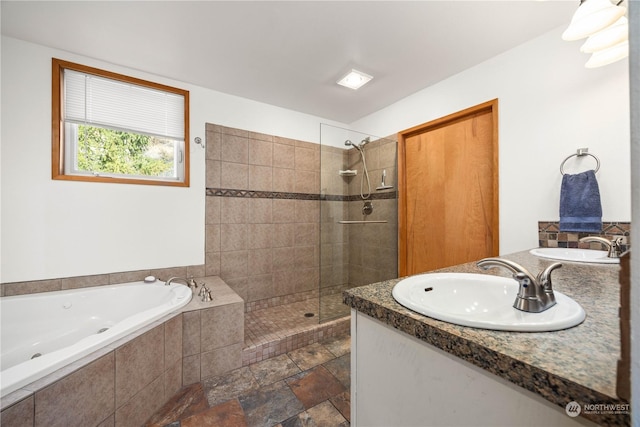 bathroom featuring separate shower and tub and vanity