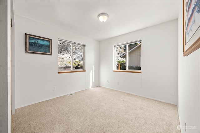 unfurnished room with carpet and plenty of natural light