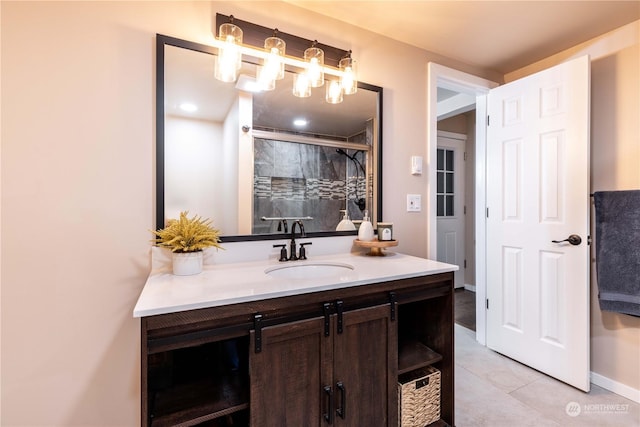 bathroom featuring tiled shower, vanity, and tile patterned floors