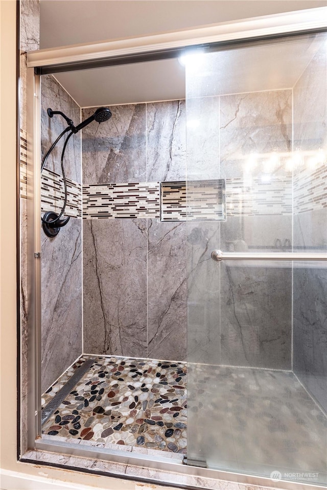 bathroom with a tile shower