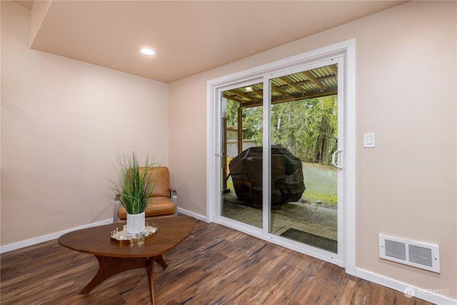 doorway featuring recessed lighting, wood finished floors, visible vents, and baseboards