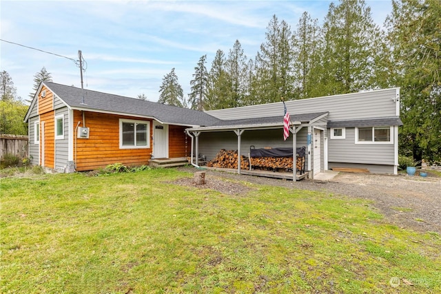 ranch-style house with a front lawn, gravel driveway, and a jacuzzi