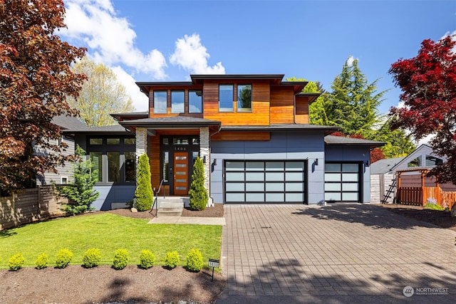 view of front of house featuring a front yard and a garage