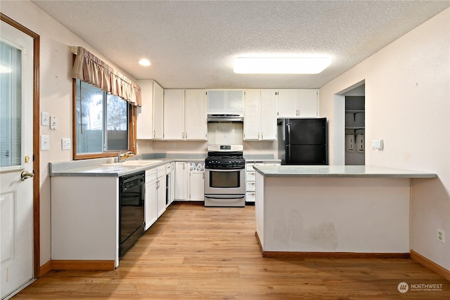 kitchen with black appliances, white cabinets, sink, a textured ceiling, and light hardwood / wood-style floors