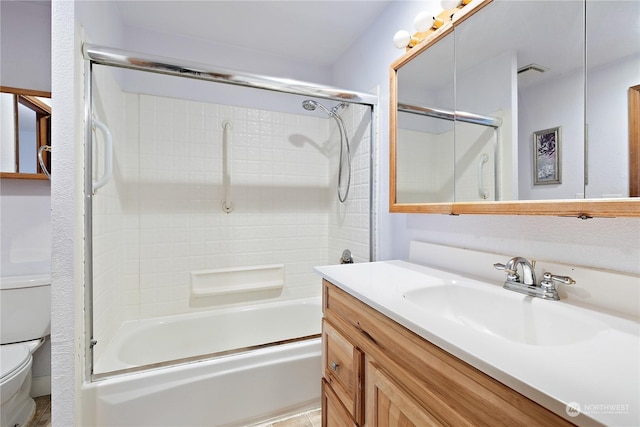 full bathroom featuring shower / bath combination with glass door, vanity, and toilet