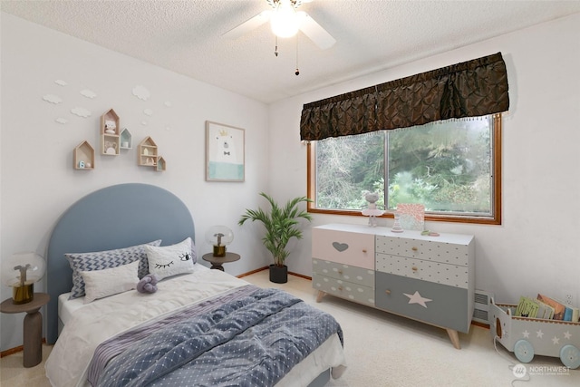 carpeted bedroom featuring ceiling fan and a textured ceiling