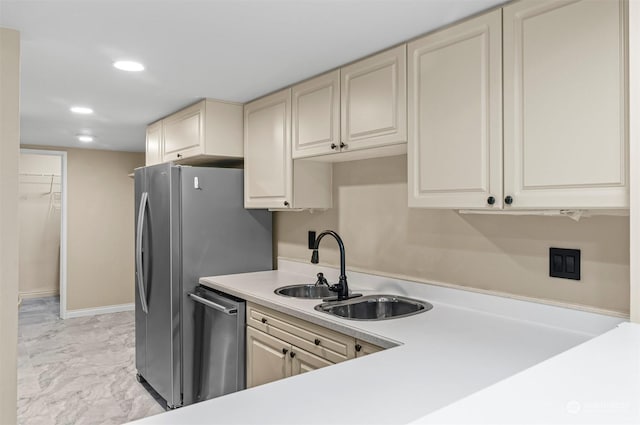 kitchen featuring sink, stainless steel dishwasher, and cream cabinetry