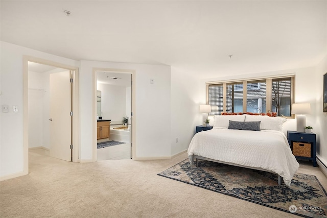 bedroom with light colored carpet and ensuite bath