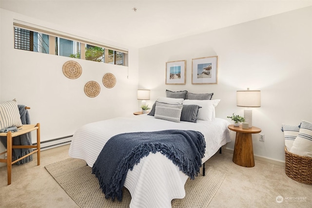 bedroom featuring light colored carpet and a baseboard heating unit