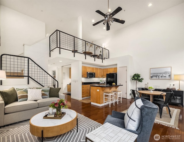2324 1st Ave Unit 202, Seattle, WA 98121 - living area featuring high vaulted ceiling, stairs, dark wood-type flooring, a ceiling fan, and recessed lighting