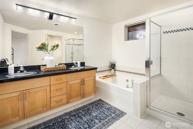 2324 1st Ave Unit 202, Seattle, WA 98121 - bathroom with tile patterned floors, a shower stall, a garden tub, and double vanity