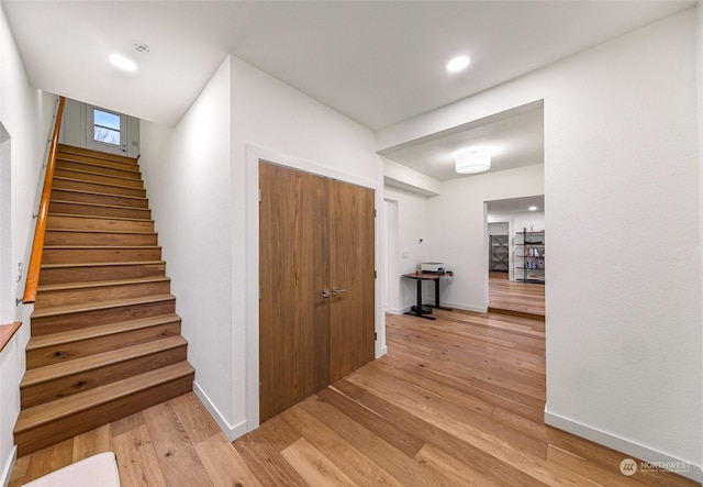 staircase featuring wood-type flooring