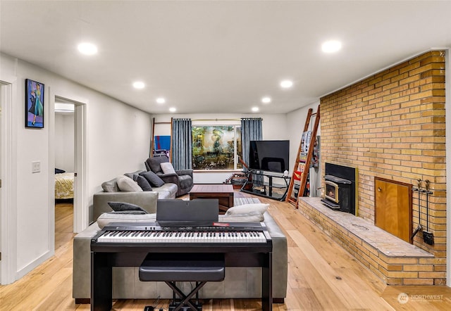 living room featuring a wood stove and light hardwood / wood-style floors