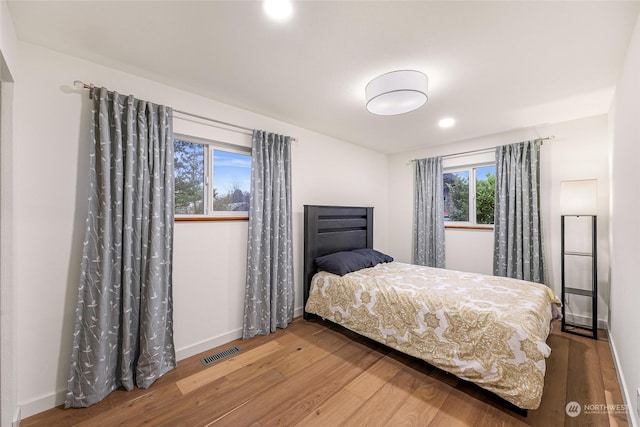 bedroom with hardwood / wood-style flooring