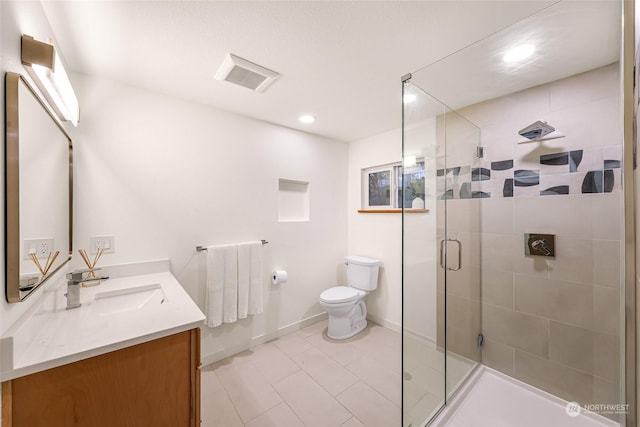 bathroom with vanity, an enclosed shower, and toilet