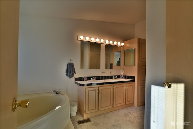 full bath featuring carpet, double vanity, visible vents, a sink, and a bath