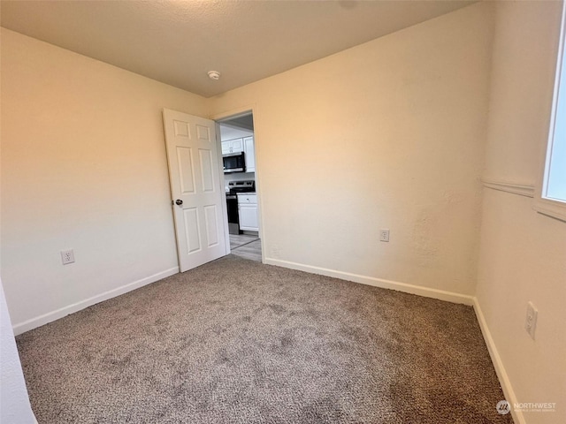 empty room featuring carpet flooring